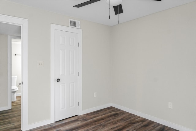 unfurnished bedroom with visible vents, baseboards, ceiling fan, and dark wood finished floors