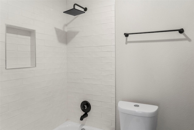 bathroom with shower / bathing tub combination and toilet