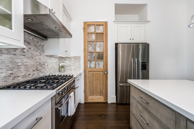 8624 Emnora Ln, Houston, TX 77080 - kitchen with appliances with stainless steel finishes, ventilation hood, dark wood-style flooring, and light countertops