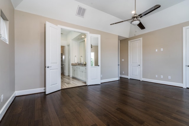 8624 Emnora Ln, Houston, TX 77080 - unfurnished bedroom with dark wood-style floors, baseboards, ensuite bathroom, and ceiling fan