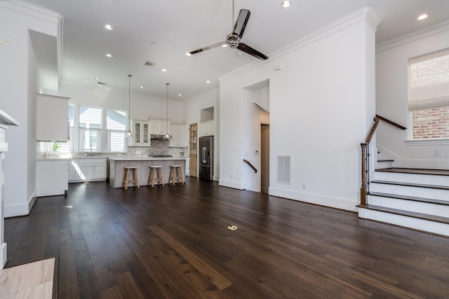 8624 Emnora Ln, Houston, TX 77080 - living area with ceiling fan, dark wood finished floors, stairway, recessed lighting, and crown molding