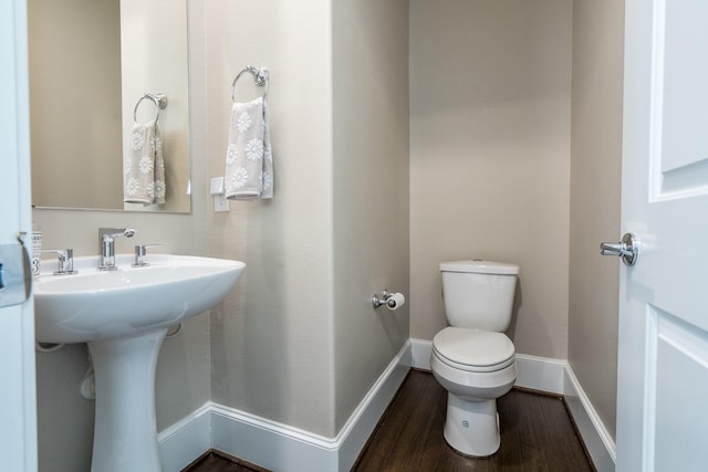 8624 Emnora Ln, Houston, TX 77080 - half bathroom with toilet, wood finished floors, baseboards, and a sink