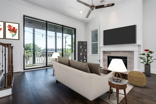 8624 Emnora Ln, Houston, TX 77080 - living room featuring ornamental molding, a ceiling fan, recessed lighting, a tiled fireplace, and dark wood-type flooring