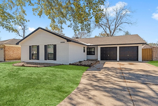ranch-style home with concrete driveway, an attached garage, a front yard, brick siding, and fence