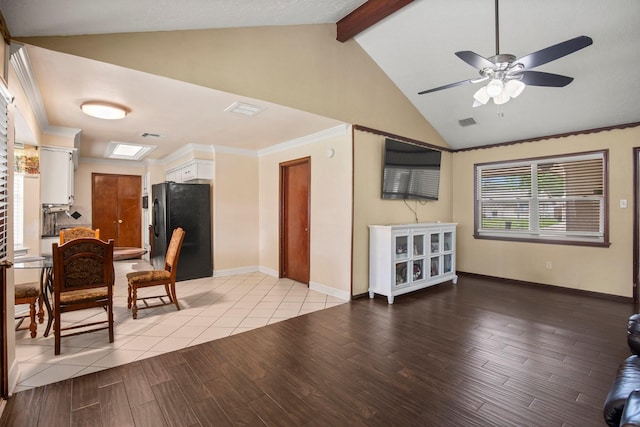 living room with a ceiling fan, light wood-style floors, vaulted ceiling with beams, and visible vents