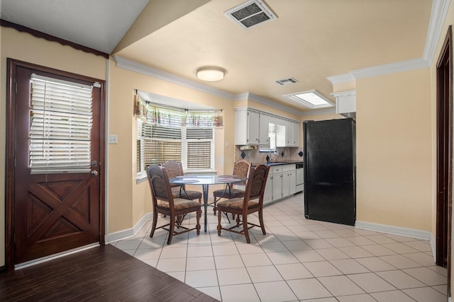 dining area with baseboards, ornamental molding, and visible vents