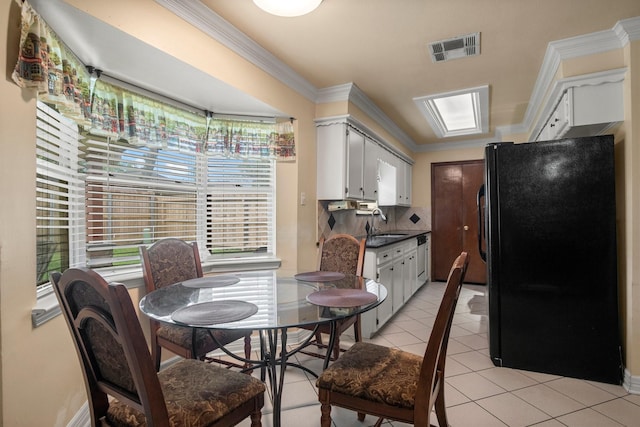 dining area featuring crown molding, visible vents, and light tile patterned floors