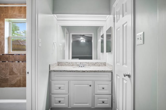 full bath featuring vanity, ceiling fan, and a tub to relax in