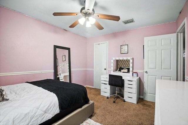 carpeted bedroom with visible vents and ceiling fan