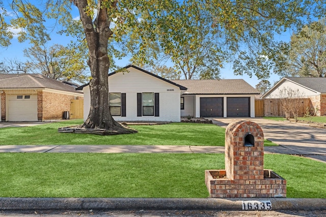 ranch-style house with concrete driveway, a front lawn, an attached garage, brick siding, and fence