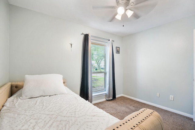 bedroom with ceiling fan, baseboards, and carpet