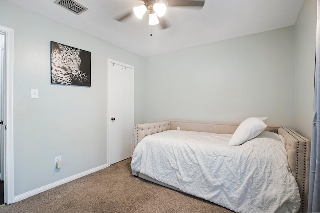 bedroom with carpet flooring, visible vents, baseboards, and a ceiling fan