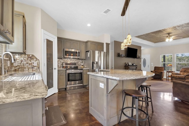 kitchen featuring concrete floors, visible vents, appliances with stainless steel finishes, a sink, and open floor plan