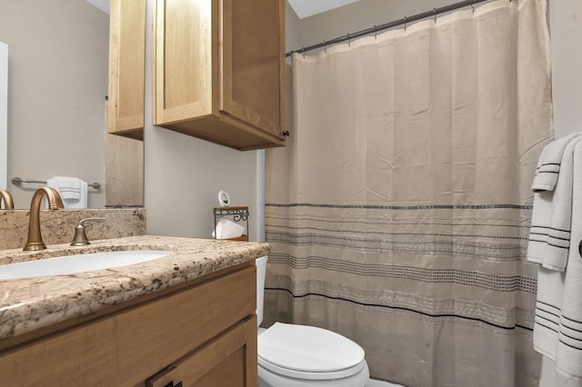 bathroom featuring vanity, a shower with curtain, and toilet
