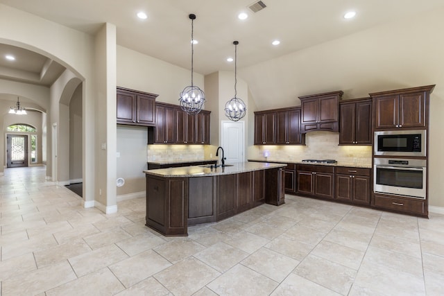 135 N Greatwood Glen Pl, Montgomery, TX 77316 - kitchen with stainless steel appliances, a sink, a chandelier, arched walkways, and recessed lighting