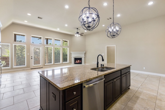 135 N Greatwood Glen Pl, Montgomery, TX 77316 - kitchen featuring stainless steel dishwasher, a sink, a ceiling fan, open floor plan, and a chandelier