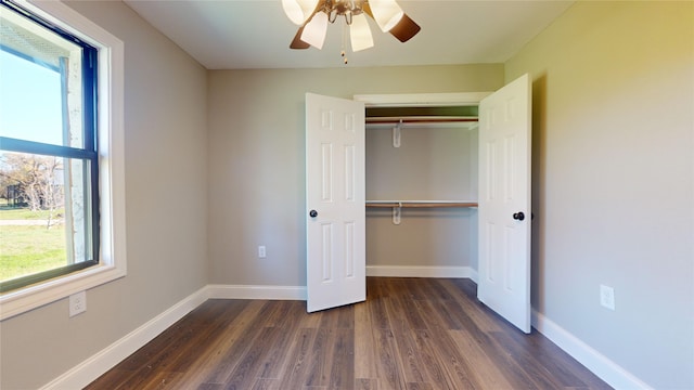603 Maple Way, Houston, TX 77015 - unfurnished bedroom featuring a closet, dark wood-style floors, multiple windows, and baseboards