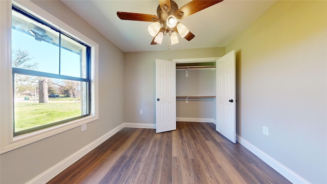 603 Maple Way, Houston, TX 77015 - unfurnished bedroom featuring dark wood-style flooring, a closet, baseboards, and ceiling fan