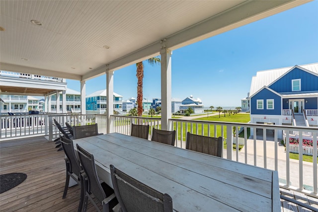 deck featuring outdoor dining space and a residential view