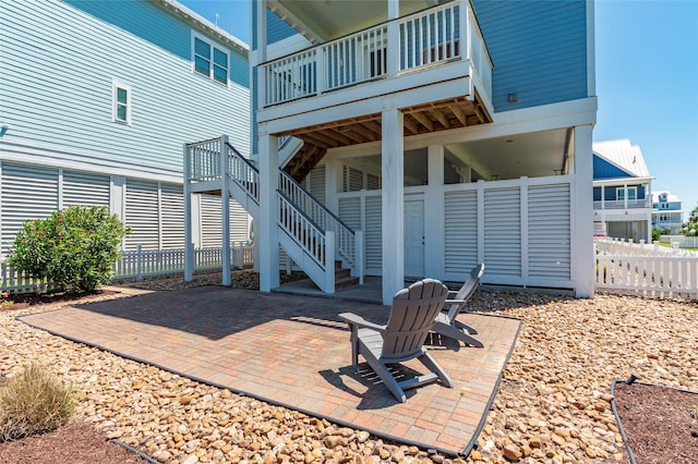 view of patio / terrace with fence and stairway