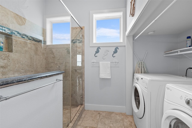 laundry room with washer and clothes dryer, laundry area, and baseboards