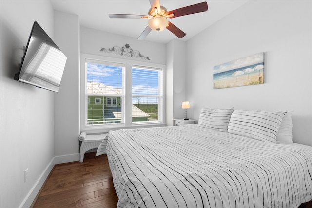 bedroom with hardwood / wood-style floors, ceiling fan, and baseboards