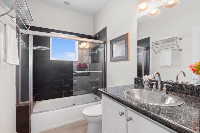 full bath with bath / shower combo with glass door, vanity, toilet, and tile patterned flooring