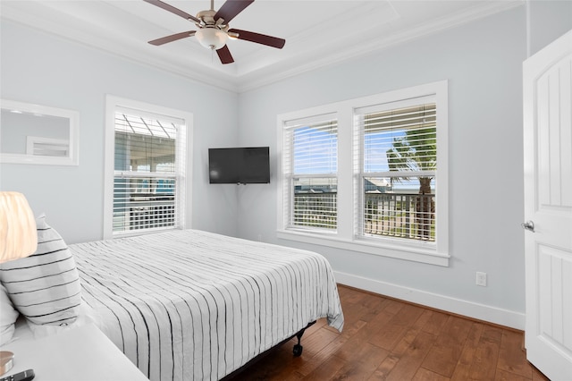 bedroom with baseboards, wood-type flooring, multiple windows, and ornamental molding