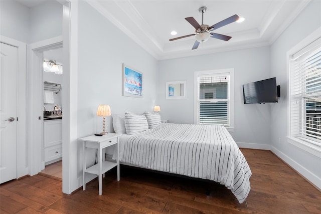 bedroom with dark wood-type flooring, crown molding, a raised ceiling, and recessed lighting