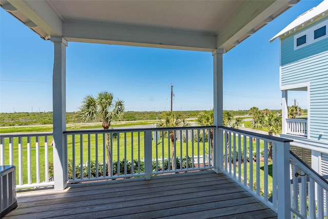 wooden deck featuring central AC unit and a lawn