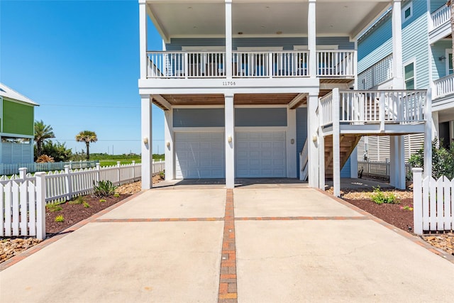 view of front of property featuring fence, a garage, and concrete driveway