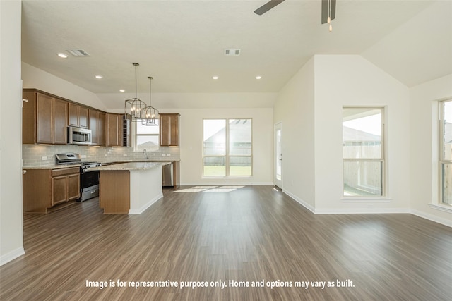 1410 Whitney Ln, Brenham, TX 77833 - kitchen with dark wood-type flooring, appliances with stainless steel finishes, visible vents, and vaulted ceiling