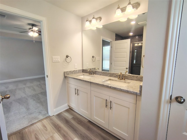 601 Greystone Ln, Angleton, TX 77515 - bathroom featuring double vanity, ceiling fan, a shower stall, baseboards, and wood finished floors