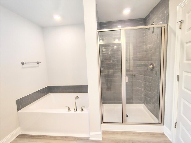 601 Greystone Ln, Angleton, TX 77515 - bathroom with a garden tub, wood finished floors, a shower stall, baseboards, and recessed lighting