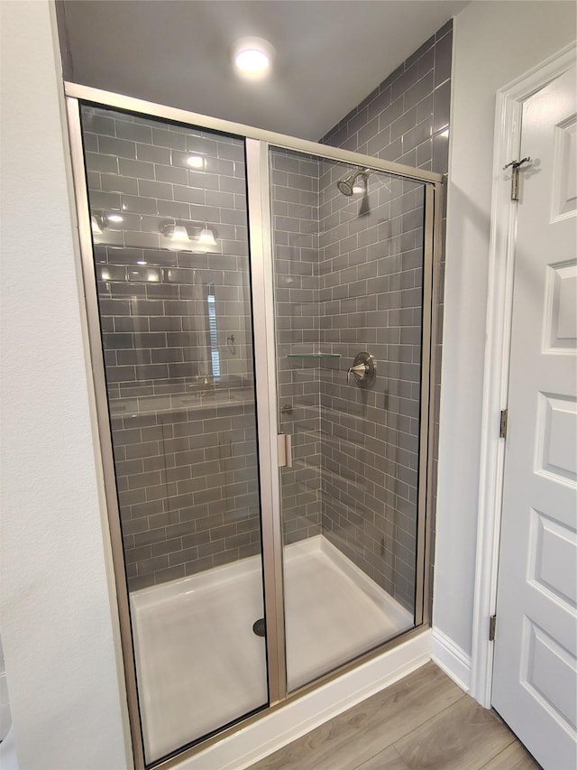 601 Greystone Ln, Angleton, TX 77515 - full bath featuring a stall shower and wood finished floors