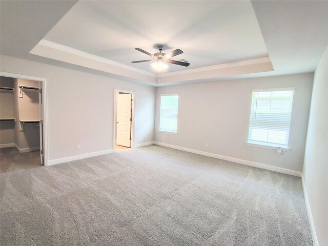 601 Greystone Ln, Angleton, TX 77515 - unfurnished bedroom featuring a tray ceiling, carpet, and ornamental molding