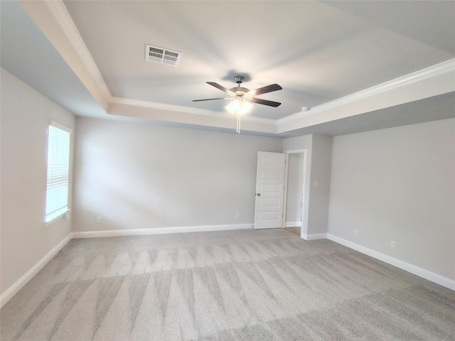 601 Greystone Ln, Angleton, TX 77515 - unfurnished bedroom featuring a tray ceiling, light carpet, baseboards, ornamental molding, and ceiling fan