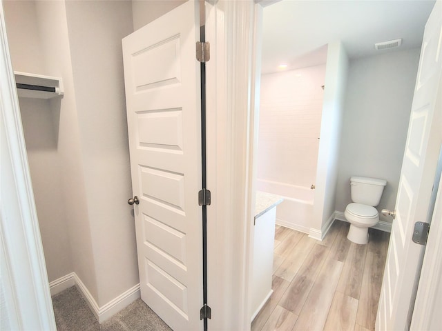 601 Greystone Ln, Angleton, TX 77515 - full bathroom with baseboards, toilet, vanity, wood finished floors, and a shower