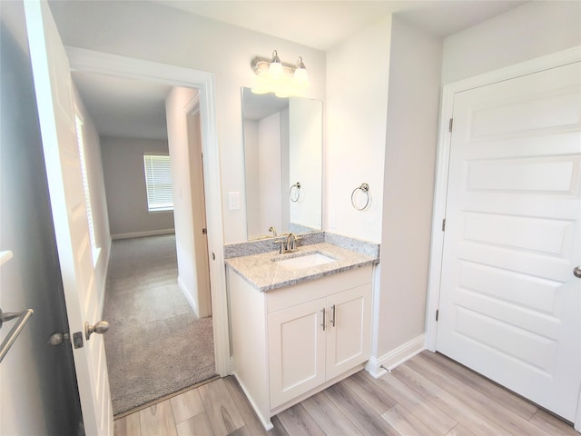 601 Greystone Ln, Angleton, TX 77515 - bathroom with vanity, wood finished floors, and baseboards