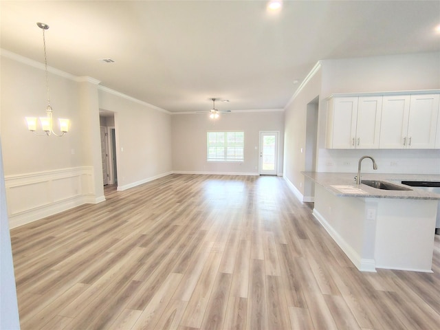 601 Greystone Ln, Angleton, TX 77515 - kitchen with a sink, open floor plan, white cabinetry, light wood finished floors, and ceiling fan