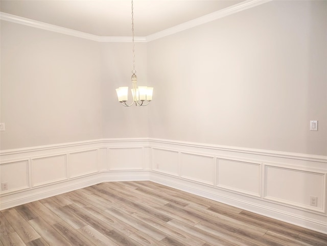 601 Greystone Ln, Angleton, TX 77515 - unfurnished room featuring crown molding, a chandelier, light wood-style floors, a wainscoted wall, and a decorative wall
