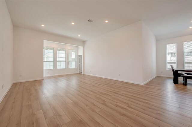 unfurnished living room featuring light wood-style floors, baseboards, visible vents, and recessed lighting