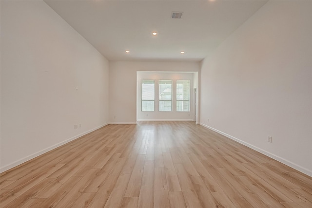 unfurnished room with light wood finished floors, baseboards, visible vents, and recessed lighting