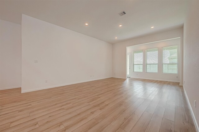 unfurnished room with visible vents, baseboards, light wood finished floors, and recessed lighting
