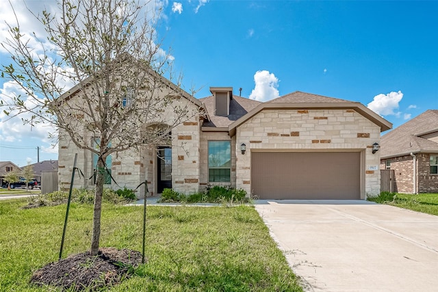 french country style house featuring a front yard, a shingled roof, an attached garage, stone siding, and driveway