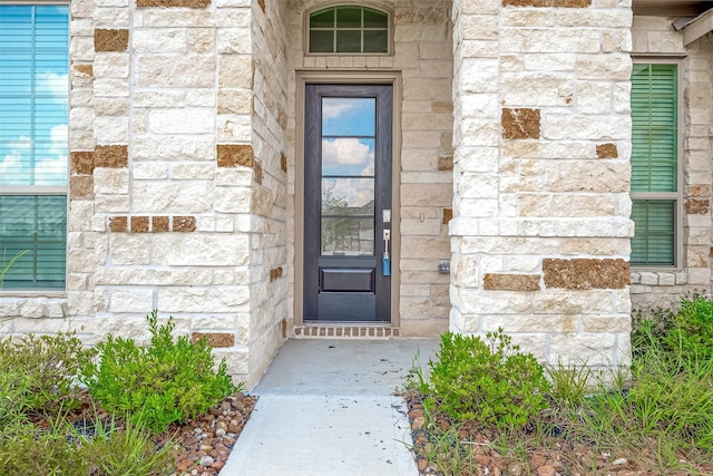 entrance to property with stone siding