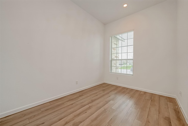 spare room with light wood finished floors, baseboards, and recessed lighting