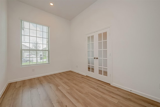 unfurnished room with french doors, baseboards, light wood-type flooring, and recessed lighting