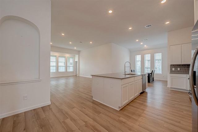 kitchen with recessed lighting, light wood-style floors, visible vents, dishwasher, and a sink