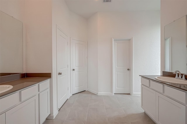 bathroom with two vanities, a sink, tile patterned flooring, and visible vents